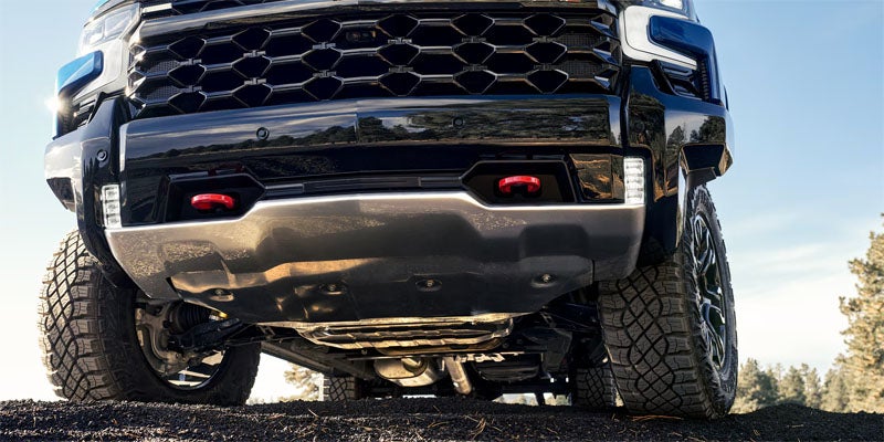 2026 Chevrolet Silverado 1500 front end in Wentzville MO showing tow hooks mounted under rugged front grille design