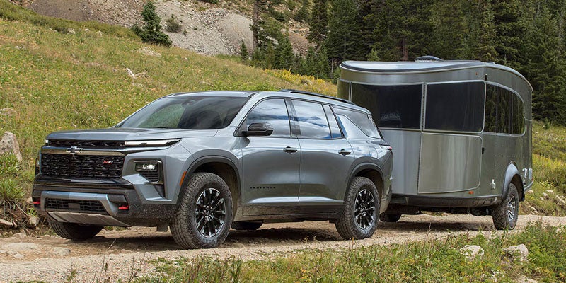 2026 Chevrolet Traverse towing a trailer near Wentzville MO on I-70 showcasing 5000 pound towing capability